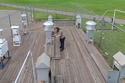 Dearborn, Michigan, Rebecca Robak, an environmental technician, checks air quality instruments at a