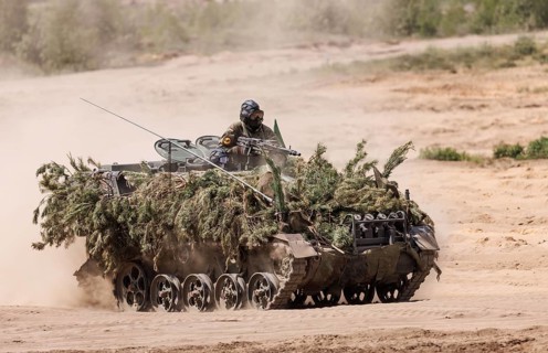 A German soldier on an M113 armoured transport vehicle, photographed during the NATO Steadfast