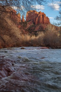 Cathedral Rock sandstone formations tower over Oak Creek at the Crescent Moon Picnic Site in