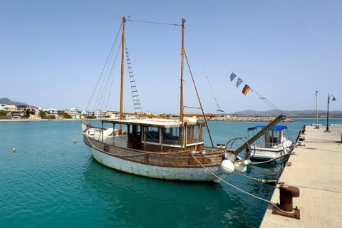 Old wooden sailing boat moored to quay wall in Kokkinos Pyrgos harbour, Kokkinos Pyrgos, Crete,