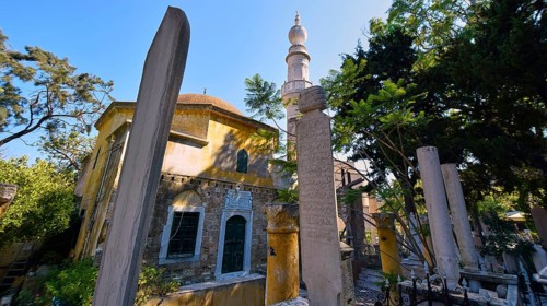 Tomb, Admiral Murat Reis, Historic mosque-like building with minaret, tombstones in the foreground