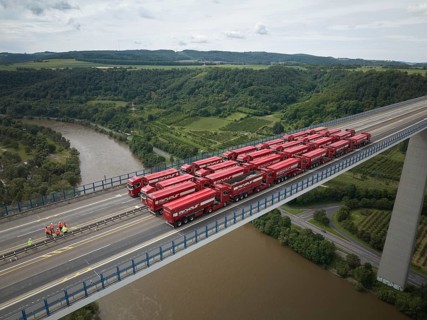 Trucks with a total weight of 960 tonnes stand on the Moselle valley bridge in Winningen during a