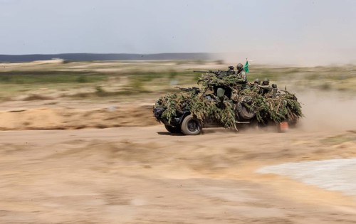 Dutch soldiers on a camouflaged Serval during the NATO Steadfast Defender large-scale manoeuvre in