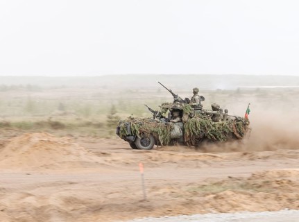 Dutch soldiers on a camouflaged Serval during the NATO Steadfast Defender large-scale manoeuvre in