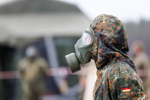 German soldiers from an NBC defence unit in protective clothing practise decontamination during the