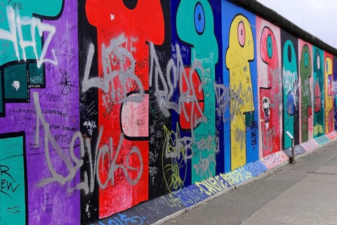 Long wall with colourful graffiti and inserted texts and symbols, mural, East Side Gallery,
