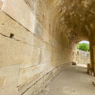 Wall of archway behind amphitheatre carved written chiselled laws City law of Gortys carved in