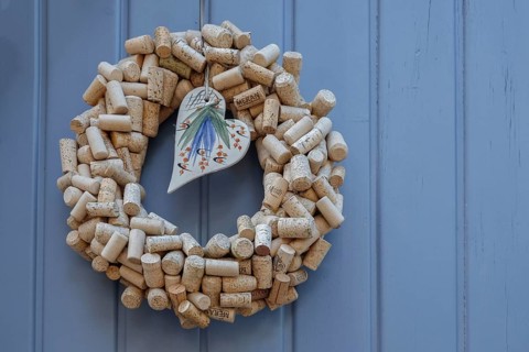 Door wreath made of wine corks with a porcelain heart on an old Tor tor, Southern Palatinate,