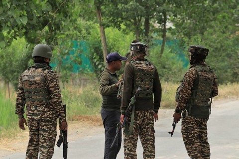 Soldiers in camouflage uniforms talking on a road, with weapons and gear visible, Encounter,