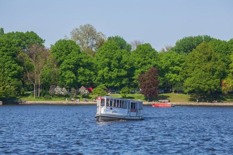 Excursion steamer on the Inner Alster Lake with park Kleiner Park Inner Alster Lake in spring,