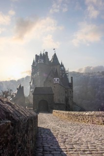 View of Eltz Castle. A landscape in autumn on a frosty morning with ripe and fog. The famous castle