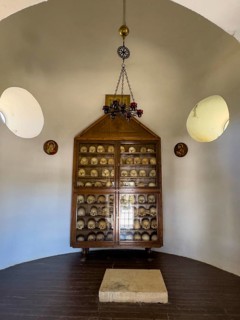 Historic ossuary with cabinet Showcase with old skulls skeletonised heads of monks from UNESCO