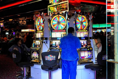 Las Vegas, Nevada, USA, North America, People playing slot machines in a busy casino, Las Vegas