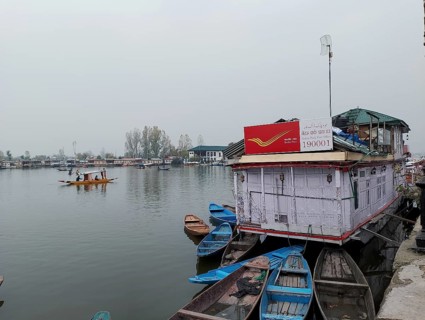 Floating post office in Srinagar, kashmir Docked houseboats and wooden boats on calm water under an