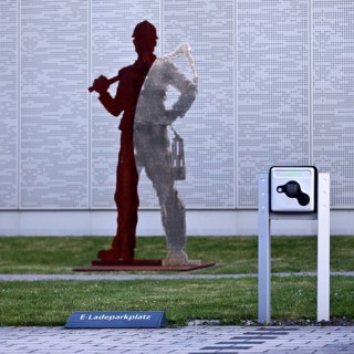 E-charging car park in front of miner's sculpture, Pluto colliery, structural change, Wanne-Eickel,