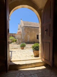 View through door Tor tor archway archway on back of two-aisled church building church monastery