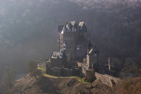 View of Eltz Castle. A landscape in autumn on a frosty morning with ripe and fog. The famous castle