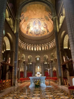 Sacred church interior with mosaic, arches and festively decorated altar, Monte Carlo, Monaco,