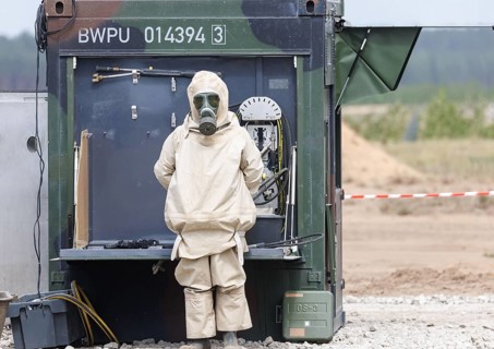 German soldiers from an NBC defence unit in protective clothing practise decontamination during the