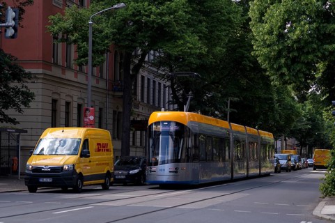 Tram, delivery vehicle, DHL delivery service, logo, Leipzig, Saxony, Germany, Europe