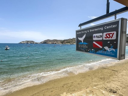 Sign of diving centre base diving school for recreational divers on beach of holiday resort Agia