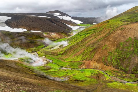 Colourful volcanic landscape with hills and snow, volcanic steaming hot springs, Laugavegur