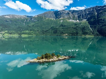 Aerial view over the Lustrafjord, the inner branch of the Sognefjord, island with trees, near