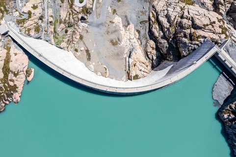 Aerial view of reservoir dam Barrage du Vieux Emosson and mountain hut Cabane Vieux Emosson,