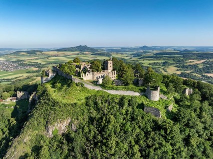Aerial view of the volcanic cone Hohentwiel with Germany's largest fortress ruins, on the horizon
