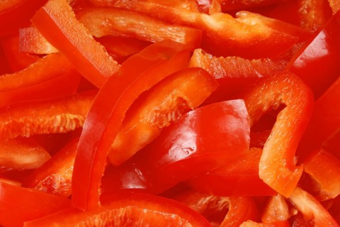 Organic background made of red bell pepper slices