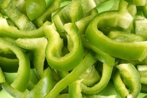 Organic background made of green bell pepper slices