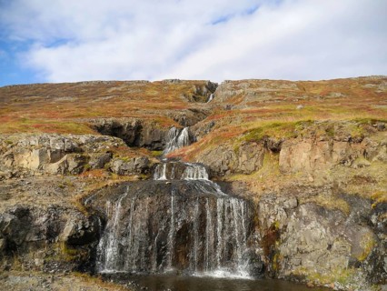 Autumn landscape with waterfall at Isafjordur in the northwest of Iceland