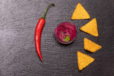 Onion salsa with chips on slate