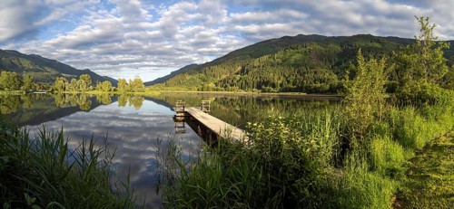 Footbridge leading into a lake, Gaishorner See in the evening light, panoramic view, Gaishorn am