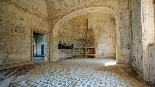 Dilapidated house with arched architecture, a fireplace and walls full of doodles, Mussolini Villa,