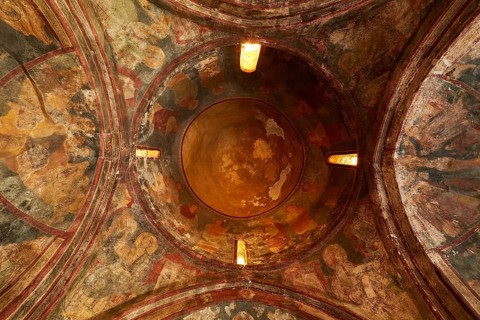View inside a dome with ancient murals and ornate decorations, Byzantine chapel of Agios Nikolaos