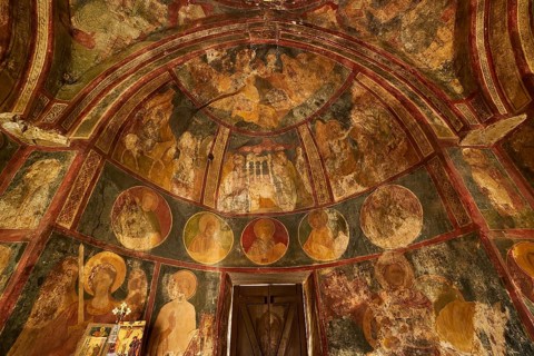 A frescoed church interior showing circular portraits and religious art, Byzantine Chapel of Agios