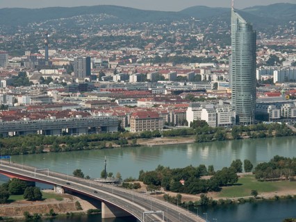 Panorama of an urban landscape with a dominating skyscraper next to a river, Vienna, Austria,