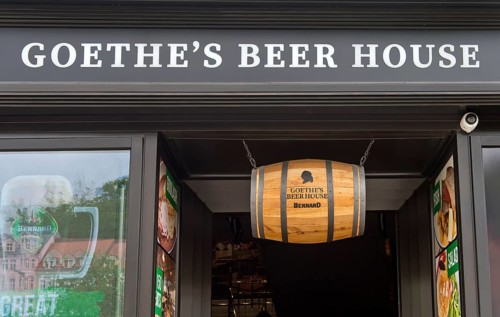 Beer barrel hanging above the entrance to Goethe's Bierhaus, Karlovy Vary, Bohemia, Czech Republic,