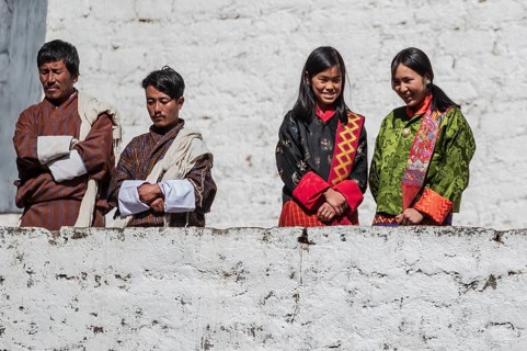 Bhutanese people in traditional clothes watching the annual Tsechu of Trongsa Dzong, Bhutan, Asia