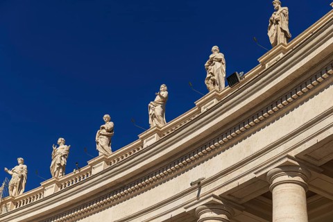 Statues at the Vatican St. Peters Square against blue sky