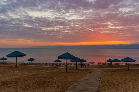 Sunset at Dead Sea at the beach of the Holiday Inn Hotel