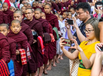 AMARAPURA, MYANMAR, JANUARY 12, 2018: Monks who live in the Mahagandayon monastery come out to