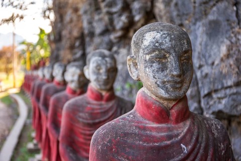 Long row of monk statues at Kaw Ka Thaung cave