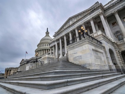 The United States capitol building with dark clouds above