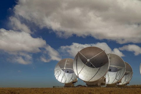 Four satellite dishes out of 60 of ESO's ALMA array pointed to the side