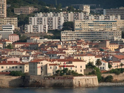 Coastal view of a town with many buildings and flat blocks and a cloudy sky, ajaccio, corsica,
