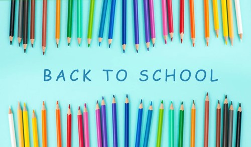 Color pencils collection in a row, back to school, drawing supplies, blue background with copy