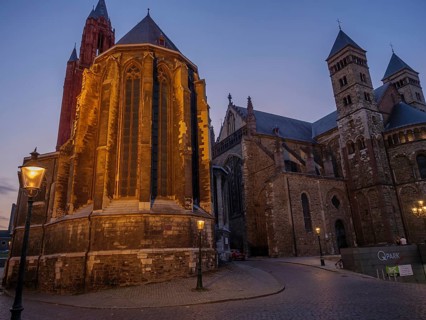 Illuminated cathedral at dusk, quiet street with lanterns, Maastricht, limburg, netherlands