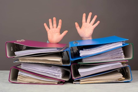 Exhausted tired worker, pile of file folders, hands up, burnout, stress and overworked, pressure at